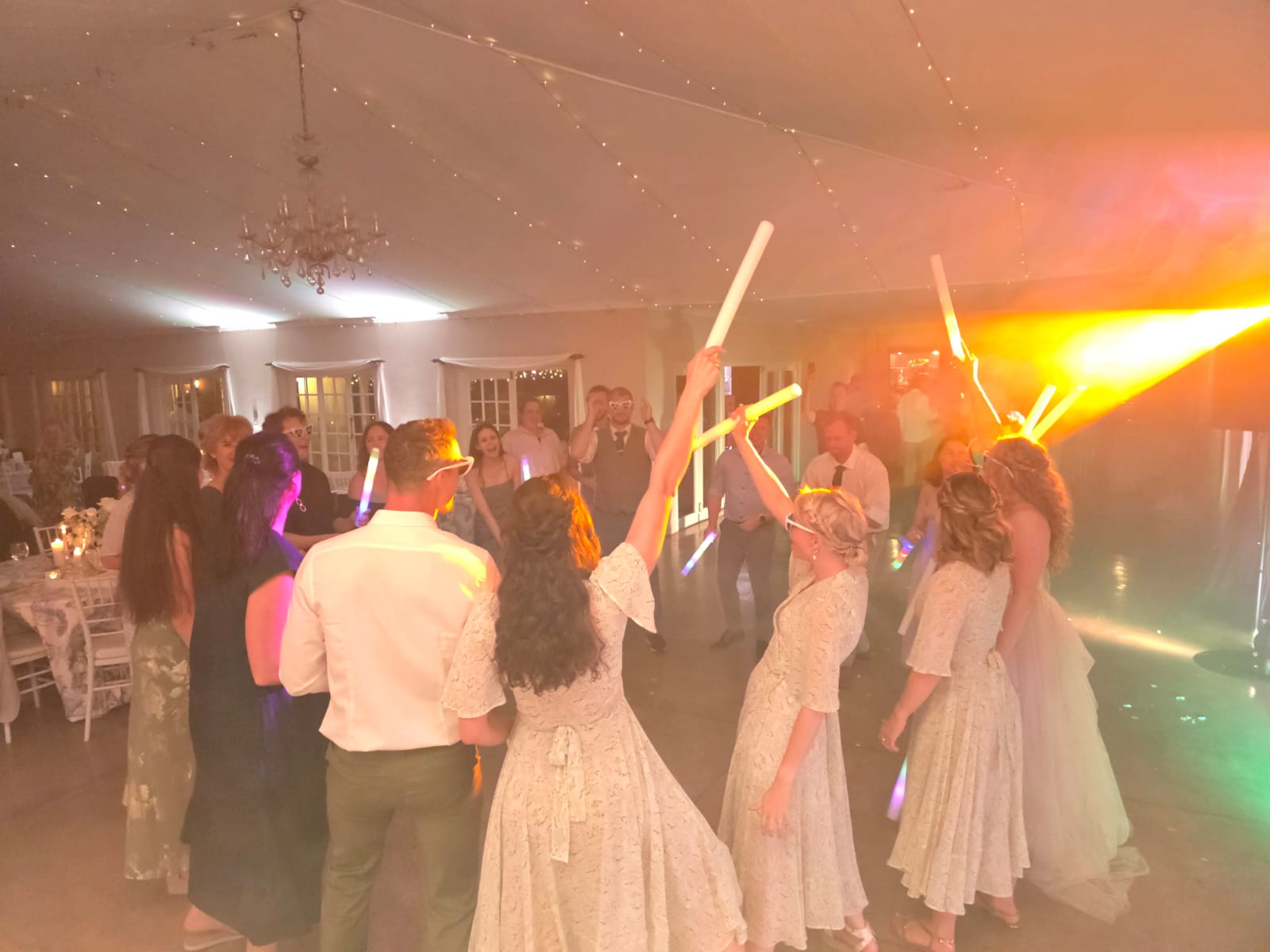 Wedding guests dancing with glowsticks on the dancefloor at Providence wedding reception
